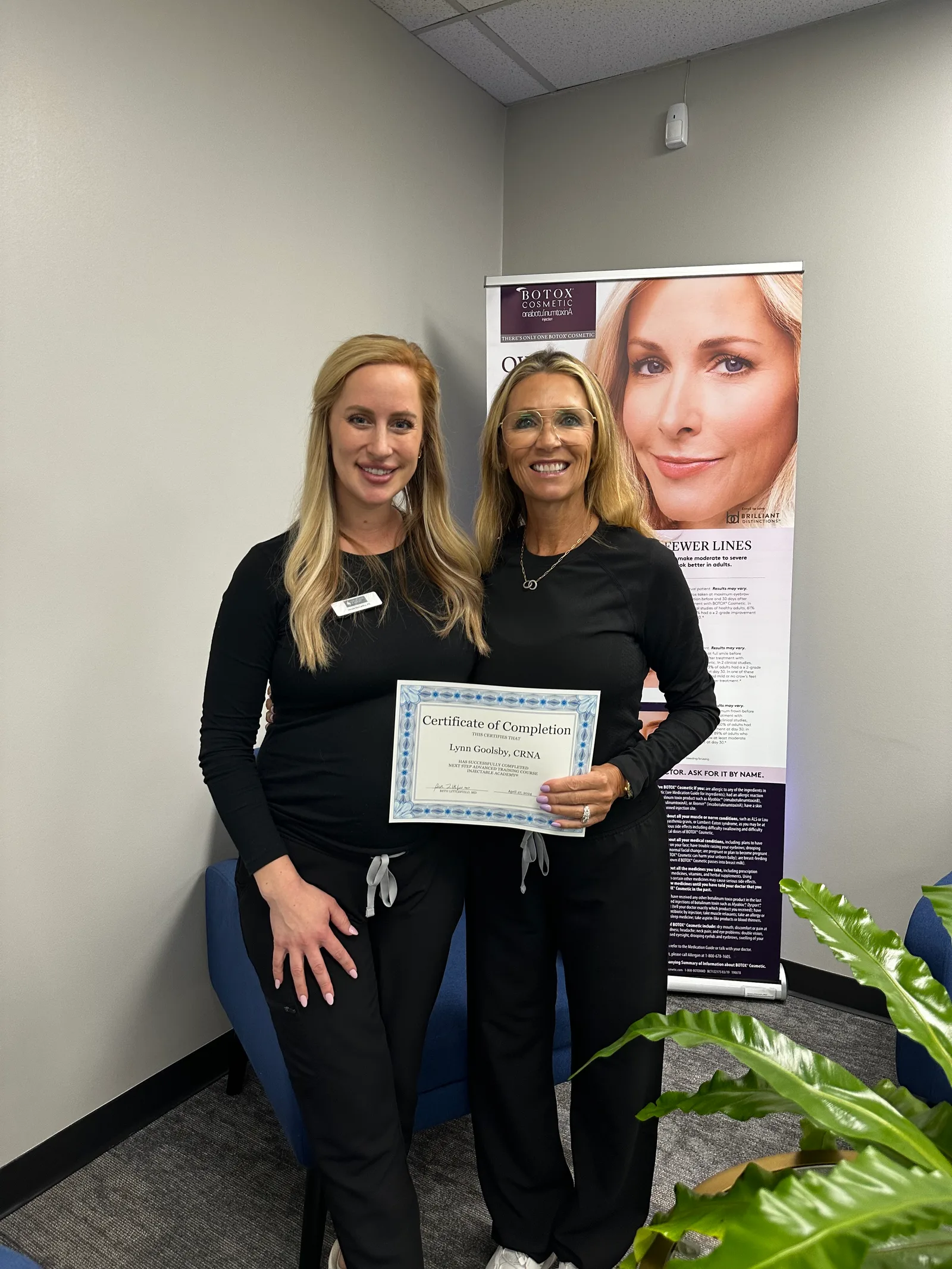 A NEXT STEP participant holds a certificate with an Academy instructor