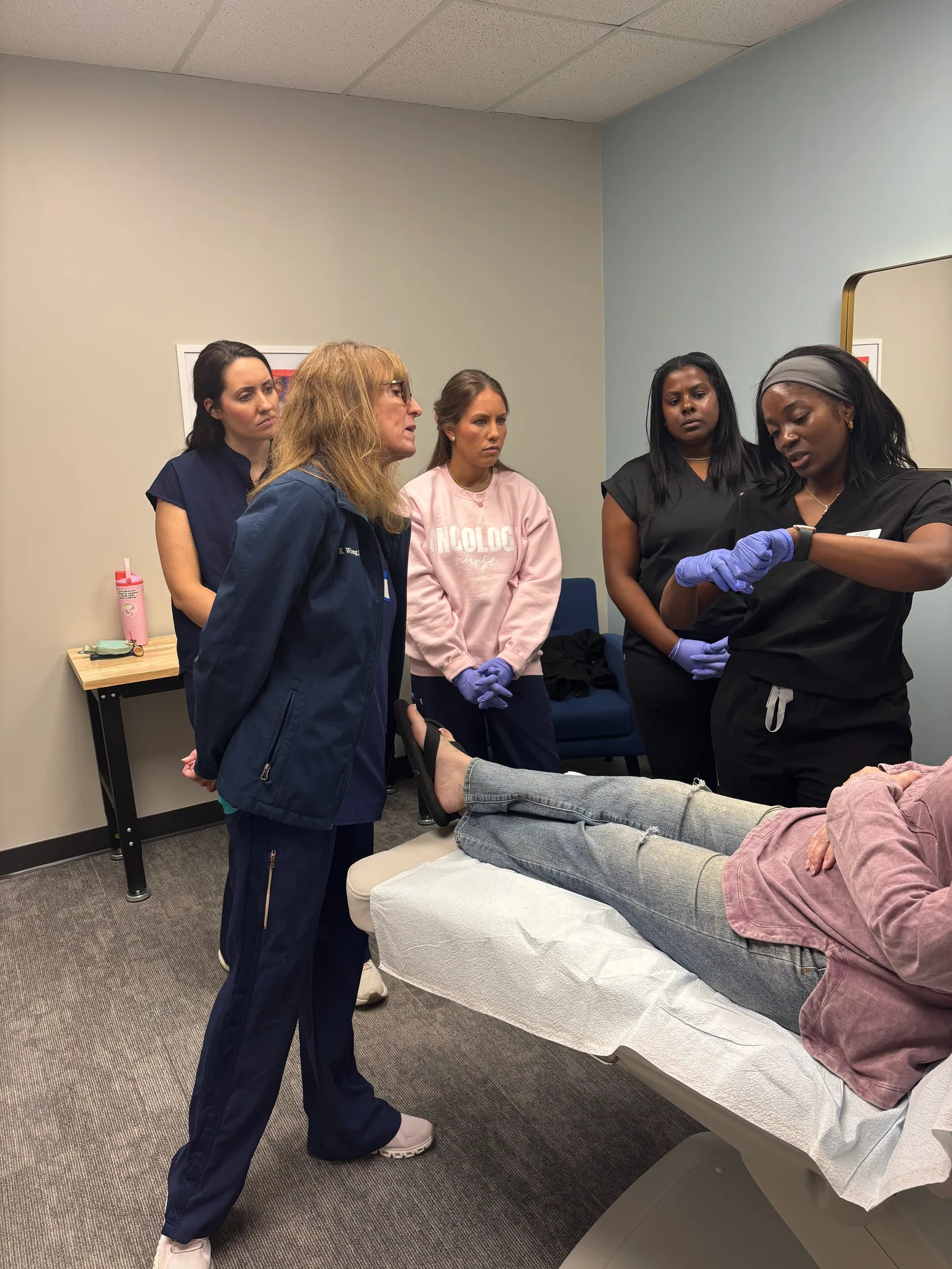 An instructor guides a student while classmates observe in Atlanta