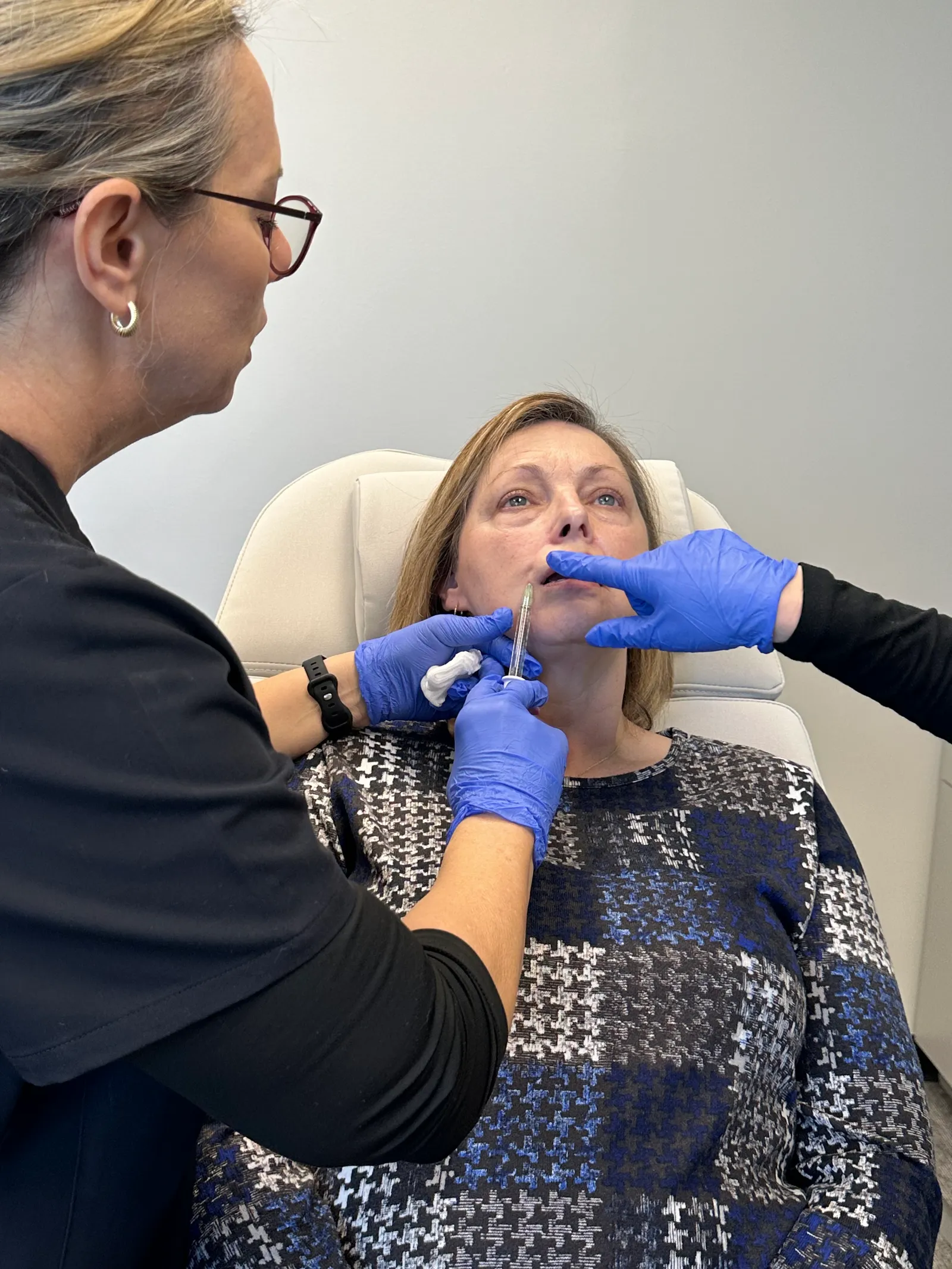 A NEXT STEP participant practices on a live model with an instructor guiding her technique in Atlanta