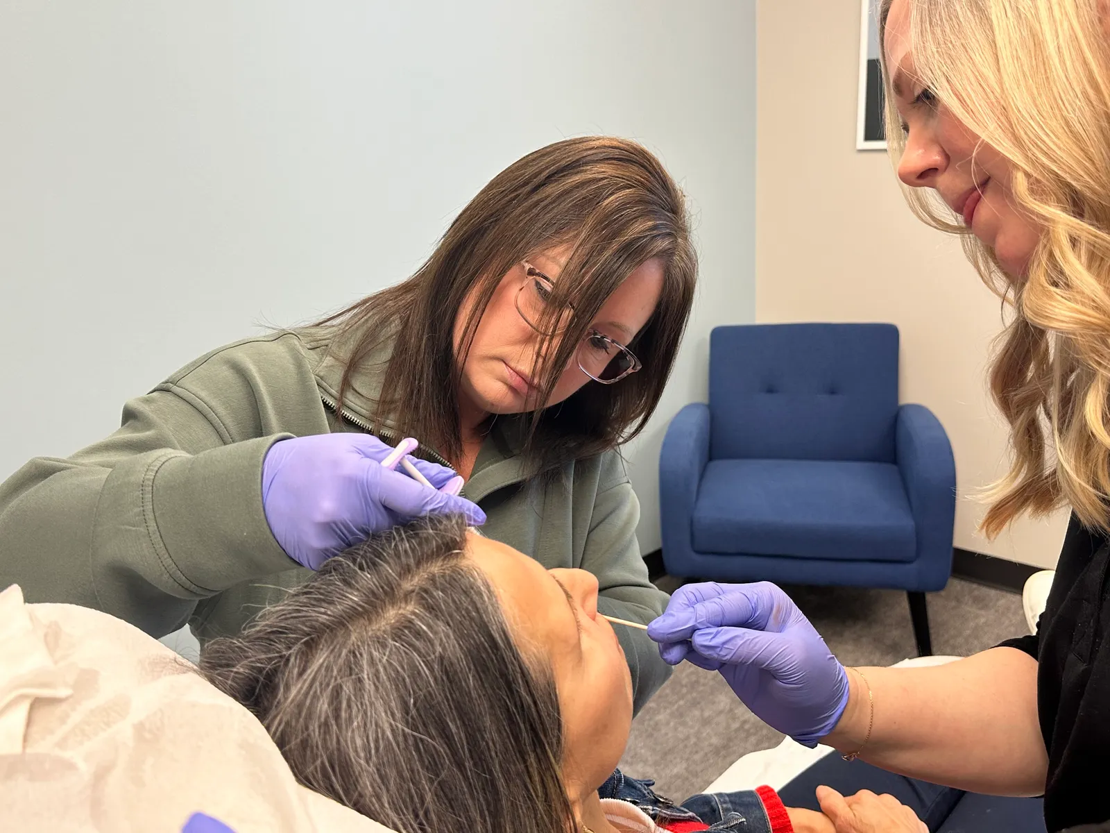 A NEXT STEP participant practices with a live model while an instructor observes closely in Atlanta